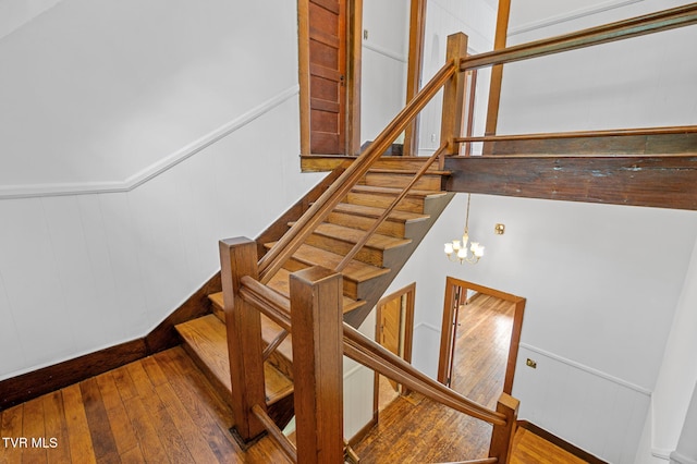 243 NW Mason Pl, Abingdon, VA 24210 - staircase featuring a chandelier, wainscoting, hardwood / wood-style flooring, and a decorative wall