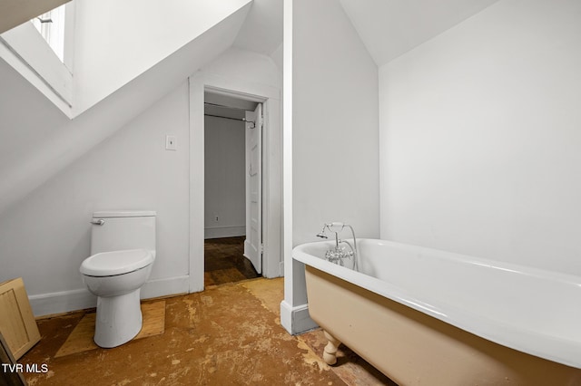 243 NW Mason Pl, Abingdon, VA 24210 - bathroom with toilet, a freestanding tub, baseboards, and vaulted ceiling with skylight