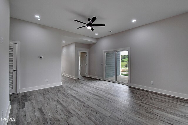 spare room featuring visible vents, wood finished floors, baseboards, ceiling fan, and recessed lighting