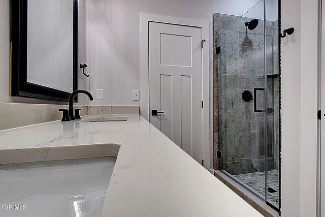 bathroom with vanity and a shower stall