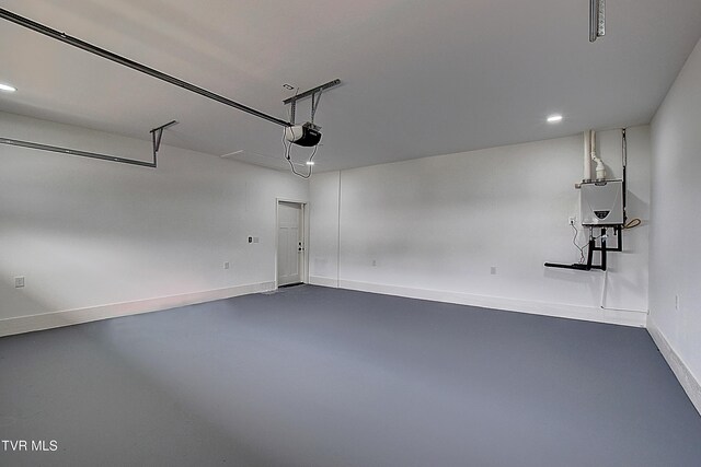 garage featuring recessed lighting, a garage door opener, and baseboards