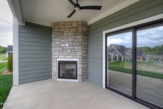 73 Slonaker Cir, Jonesborough, TN 37659 - unfurnished living room featuring a healthy amount of sunlight, wood walls, ceiling fan, and an outdoor stone fireplace