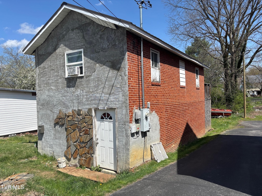 view of side of home with brick siding