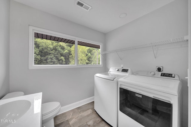 3749 Hemlock Park Cir, Kingsport, TN 37663 - clothes washing area with laundry area, visible vents, baseboards, washer and clothes dryer, and a sink