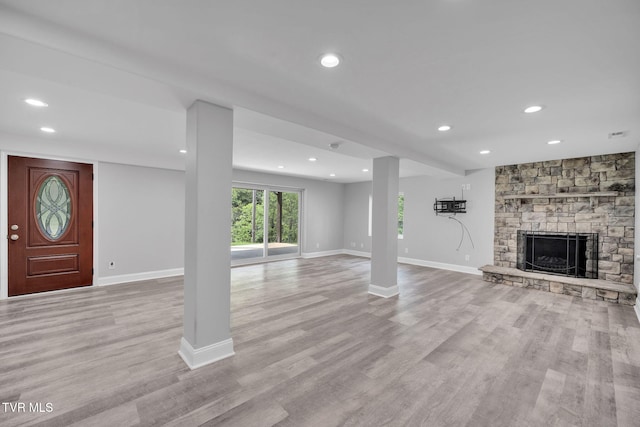 3749 Hemlock Park Cir, Kingsport, TN 37663 - unfurnished living room featuring baseboards, recessed lighting, a stone fireplace, and light wood-type flooring