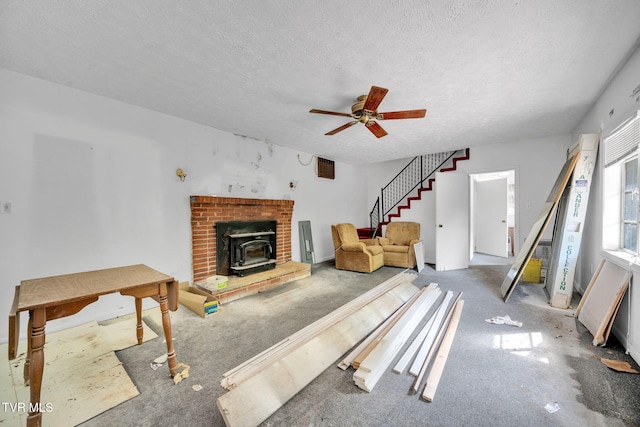 3749 Hemlock Park Cir, Kingsport, TN 37663 - living area featuring ceiling fan, a wood stove, carpet floors, a textured ceiling, and stairs