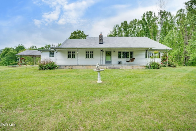 357 Webb Rd, Piney Flats, TN 37686 - rear view of property featuring a lawn, a detached carport, and a chimney