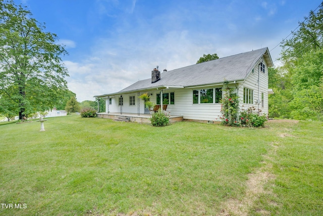 357 Webb Rd, Piney Flats, TN 37686 - back of house with covered porch, a lawn, and a chimney