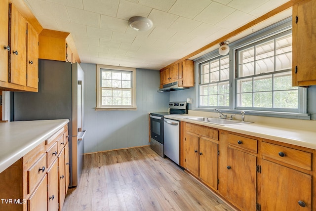 357 Webb Rd, Piney Flats, TN 37686 - kitchen featuring light wood-style floors, light countertops, under cabinet range hood, a sink, and stainless steel appliances