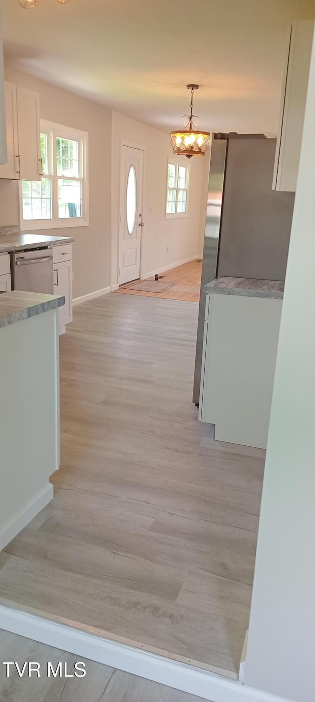 2160 Whirlwind Rd, Greeneville, TN 37743 - interior space with baseboards, light wood-style floors, and a chandelier