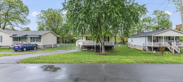 608 Walnut St, Elizabethton, TN 37643 - view of front of home featuring covered porch, crawl space, a front yard, stairs, and an outbuilding