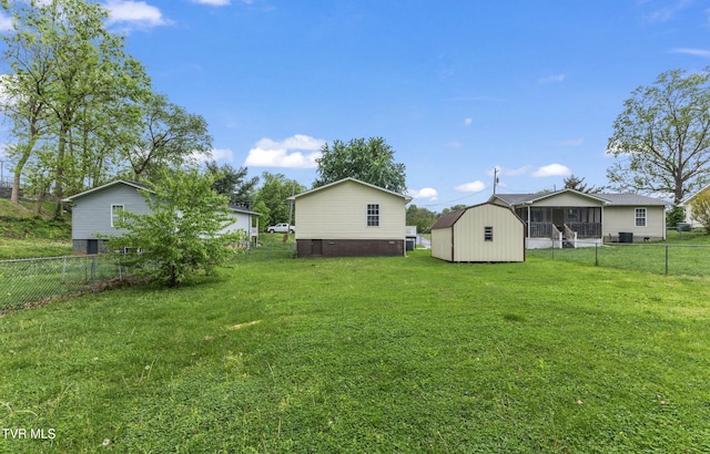 608 Walnut St, Elizabethton, TN 37643 - view of yard with a storage unit, an outbuilding, and a sunroom