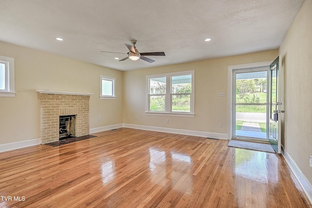 350 Texas Ave, Bristol, VA 24201 - unfurnished living room with light wood finished floors, a fireplace, a ceiling fan, baseboards, and recessed lighting