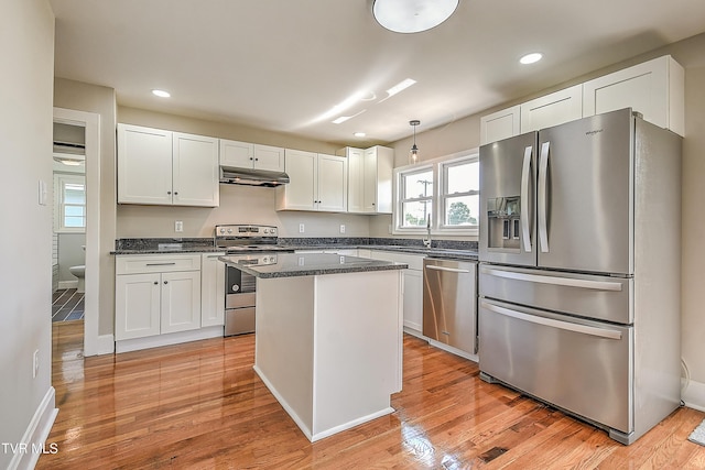 350 Texas Ave, Bristol, VA 24201 - kitchen featuring a kitchen island, under cabinet range hood, white cabinets, light wood finished floors, and stainless steel appliances