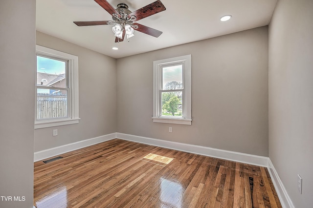 350 Texas Ave, Bristol, VA 24201 - unfurnished room with baseboards, wood finished floors, a healthy amount of sunlight, and visible vents