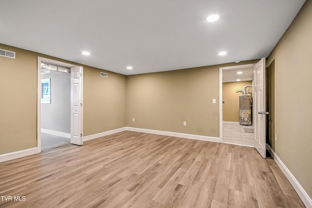 350 Texas Ave, Bristol, VA 24201 - below grade area with visible vents, baseboards, light wood finished floors, water heater, and recessed lighting