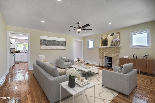 350 Texas Ave, Bristol, VA 24201 - living room with ceiling fan, a brick fireplace, hardwood / wood-style flooring, and a wealth of natural light