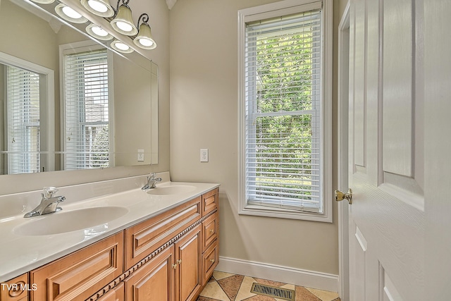 260 Dominique Ln, Greeneville, TN 37743 - bathroom with a sink, baseboards, double vanity, and visible vents