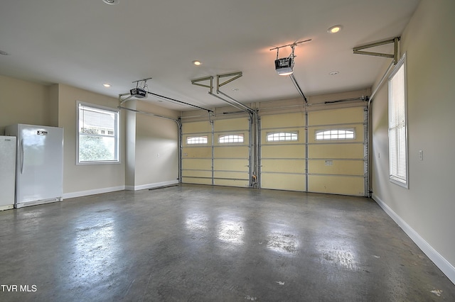 260 Dominique Ln, Greeneville, TN 37743 - garage featuring baseboards, a garage door opener, freestanding refrigerator, and recessed lighting