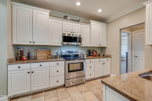 145 Grande Harbor Way, Blountville, TN 37617 - kitchen with appliances with stainless steel finishes, tasteful backsplash, light stone countertops, white cabinets, and crown molding
