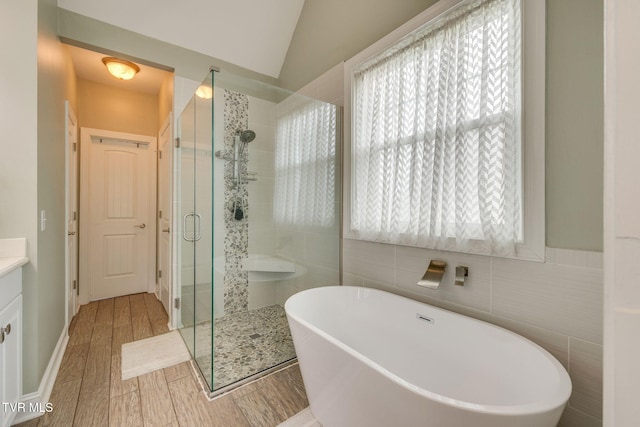 145 Grande Harbor Way, Blountville, TN 37617 - bathroom with a stall shower, a freestanding tub, vanity, wood finished floors, and lofted ceiling