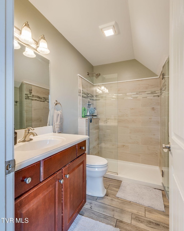 145 Grande Harbor Way, Blountville, TN 37617 - bathroom featuring a shower stall, wood finished floors, toilet, vanity, and vaulted ceiling