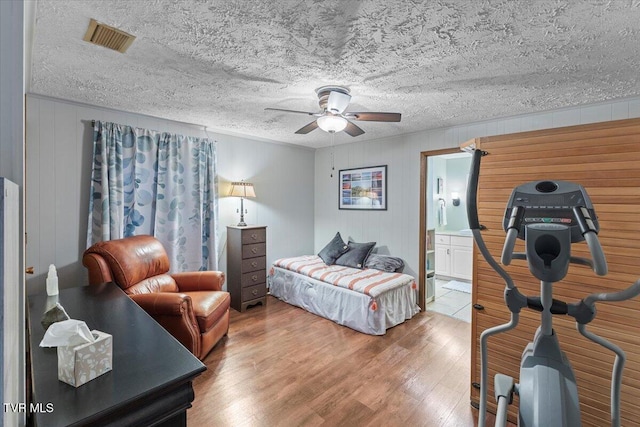196 Furches Dr, Gray, TN 37615 - bedroom with wood finished floors, connected bathroom, and ceiling fan