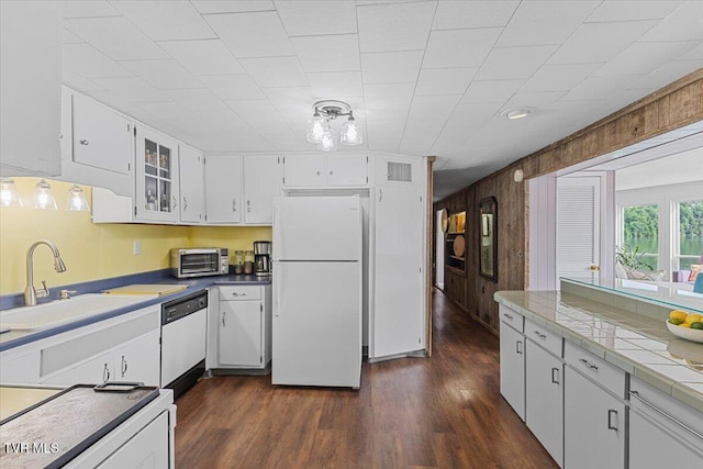196 Furches Dr, Gray, TN 37615 - kitchen with white appliances, a sink, white cabinetry, dark wood-style floors, and wooden walls