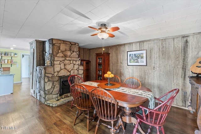 196 Furches Dr, Gray, TN 37615 - dining area with a ceiling fan, wood finished floors, a fireplace, wooden walls, and baseboards