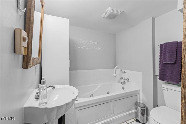 196 Furches Dr, Gray, TN 37615 - bathroom with toilet, a tub with jets, tile patterned floors, and a sink