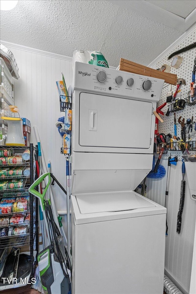 196 Furches Dr, Gray, TN 37615 - laundry area with stacked washing machine and dryer, a textured ceiling, and ornamental molding