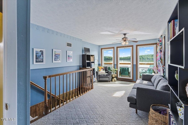 196 Furches Dr, Gray, TN 37615 - carpeted living room with a textured ceiling, a ceiling fan, and a wainscoted wall
