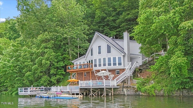 196 Furches Dr, Gray, TN 37615 - rear view of house featuring stairway, a deck with water view, and a chimney