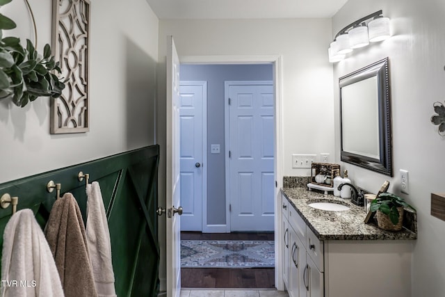 bathroom with wood finished floors and vanity