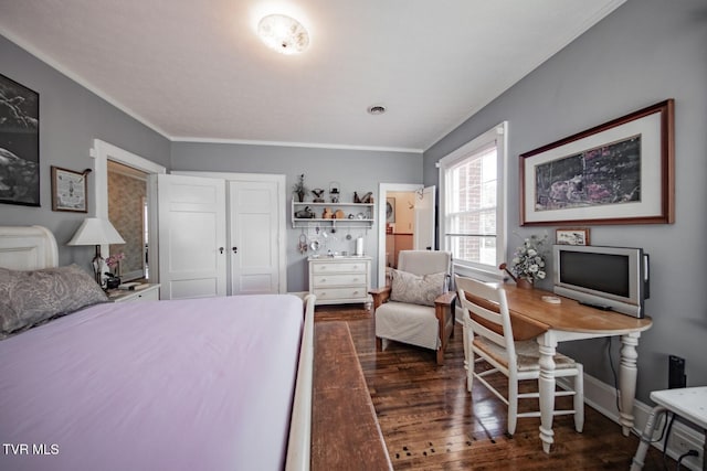 bedroom featuring crown molding, dark wood-style flooring, baseboards, and a closet