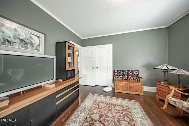 interior space featuring baseboards, ornamental molding, and dark wood finished floors