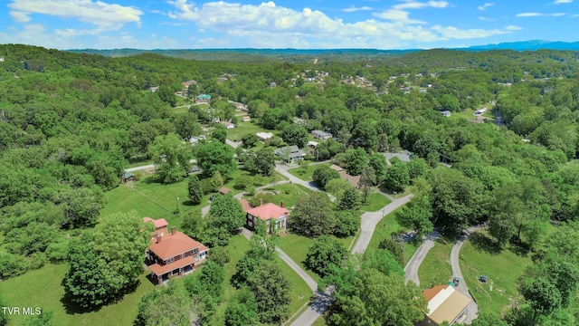 drone / aerial view with a wooded view