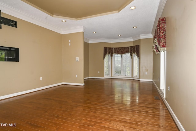 unfurnished room featuring crown molding, recessed lighting, baseboards, and hardwood / wood-style floors