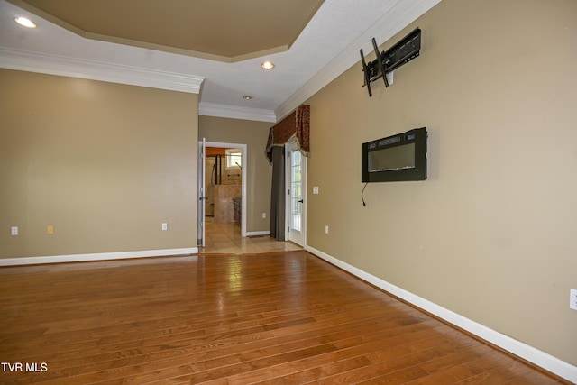 spare room with recessed lighting, baseboards, ornamental molding, and light wood-style floors
