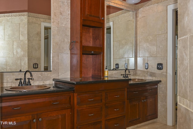 bathroom featuring double vanity, tile walls, a sink, and tasteful backsplash