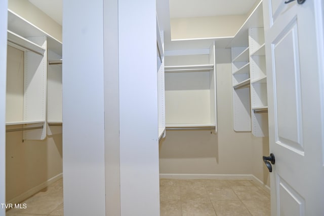 walk in closet featuring light tile patterned floors