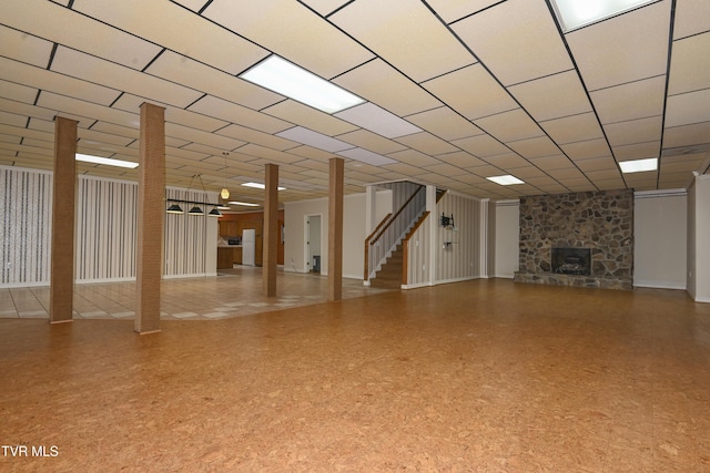 below grade area with a stone fireplace