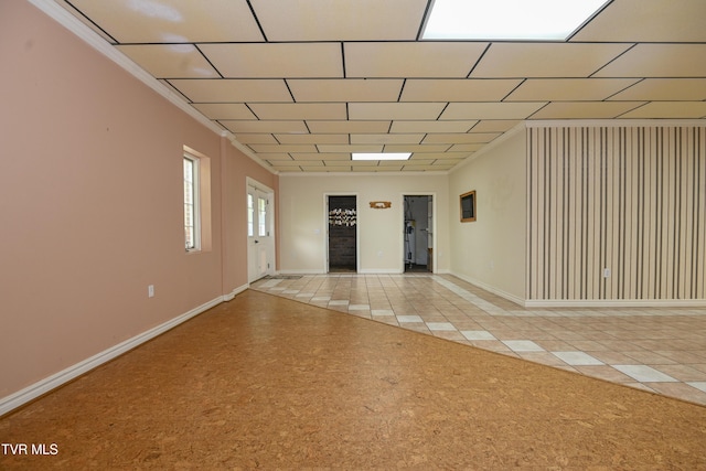 spare room featuring baseboards and light colored carpet