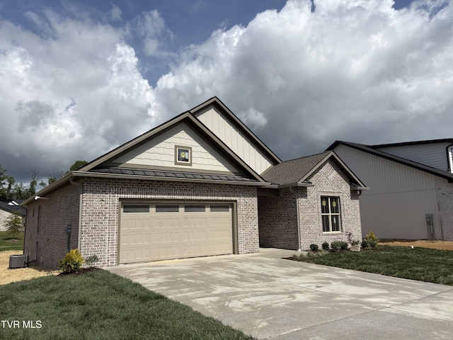 single story home with brick siding, a front lawn, driveway, and a standing seam roof