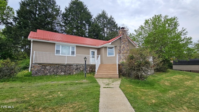 616 SE Kiser Ave, Coeburn, VA 24230 - view of front of home featuring a chimney, metal roof, and a front lawn