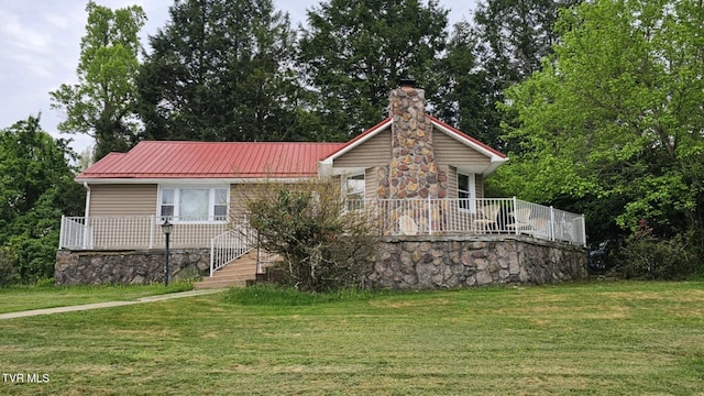 616 SE Kiser Ave, Coeburn, VA 24230 - view of front facade featuring a front lawn, a chimney, and metal roof