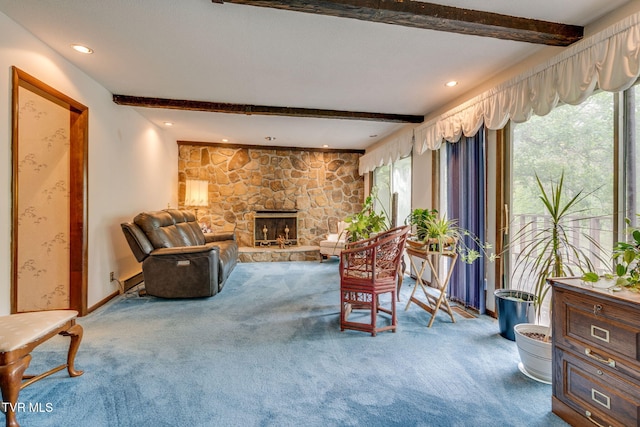 living area with carpet, beamed ceiling, a stone fireplace, and recessed lighting