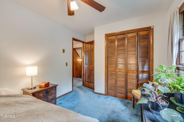 bedroom with ceiling fan, carpet floors, baseboards, and a closet