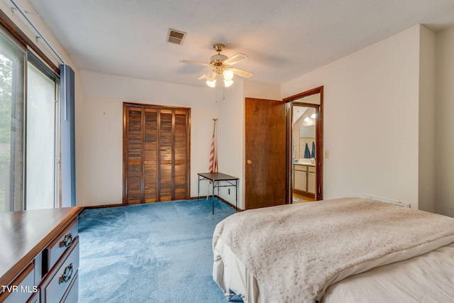 carpeted bedroom with a closet, visible vents, and a ceiling fan