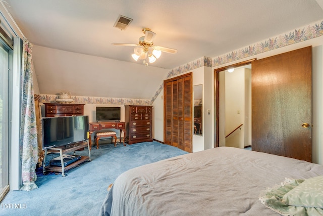 carpeted bedroom featuring a ceiling fan, visible vents, and vaulted ceiling